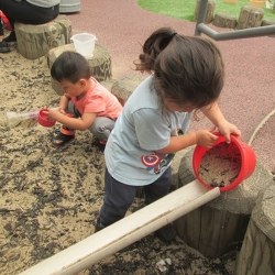 Children playing with sand during an ECE session